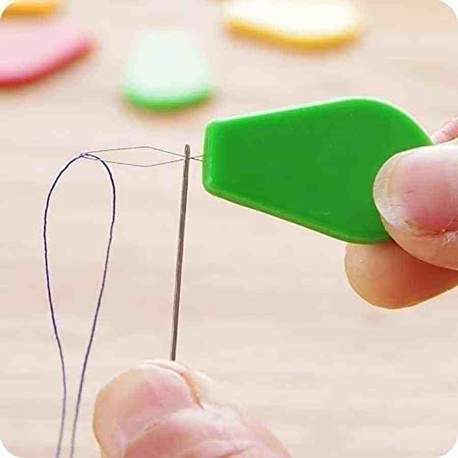 Small needle threader with colorful handles being used with thread — ONSA sewing blog
